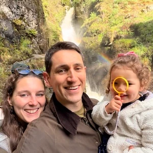 Mike Carter standing with his family in front of a waterfall